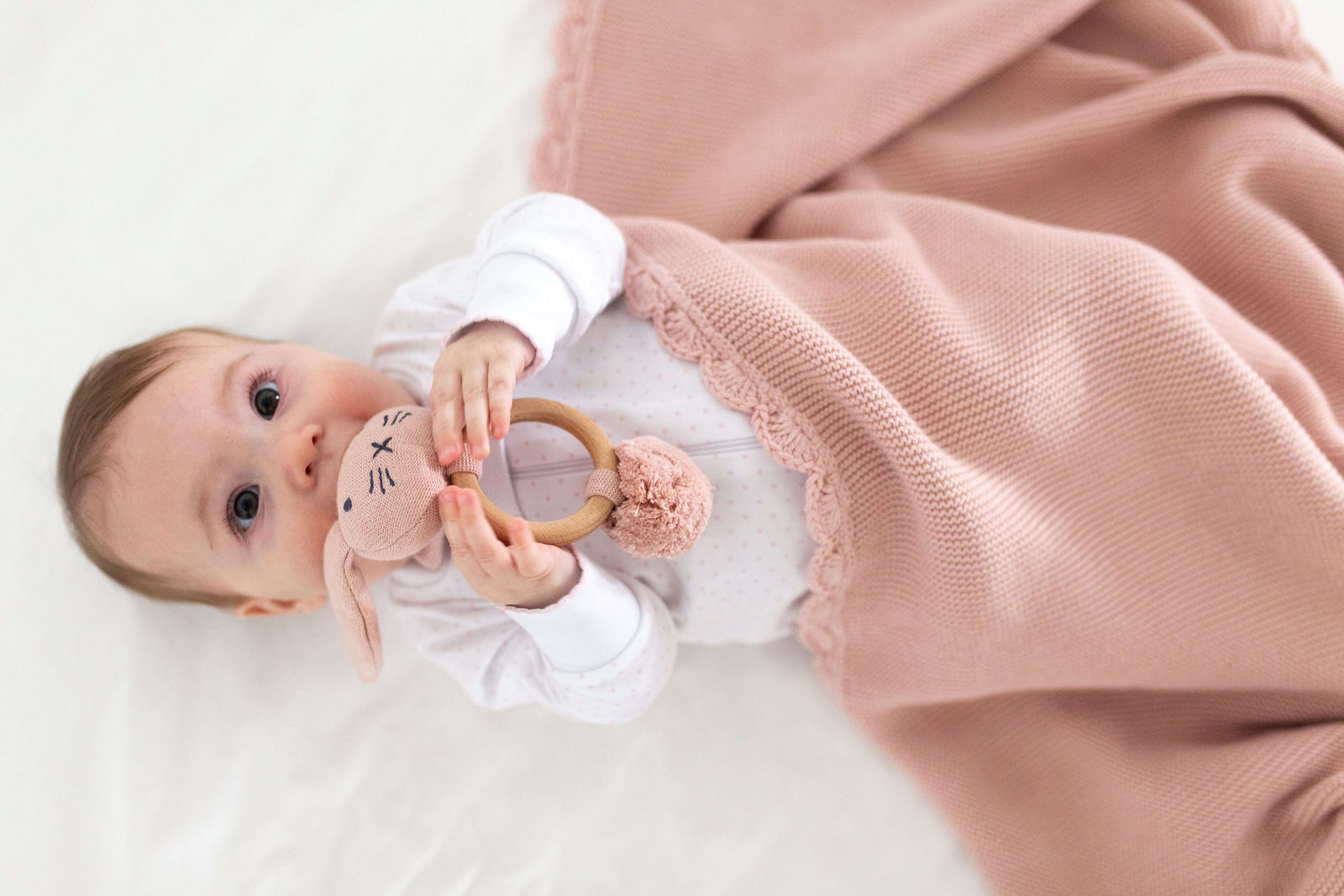 Baby playing with rabit baby rattles