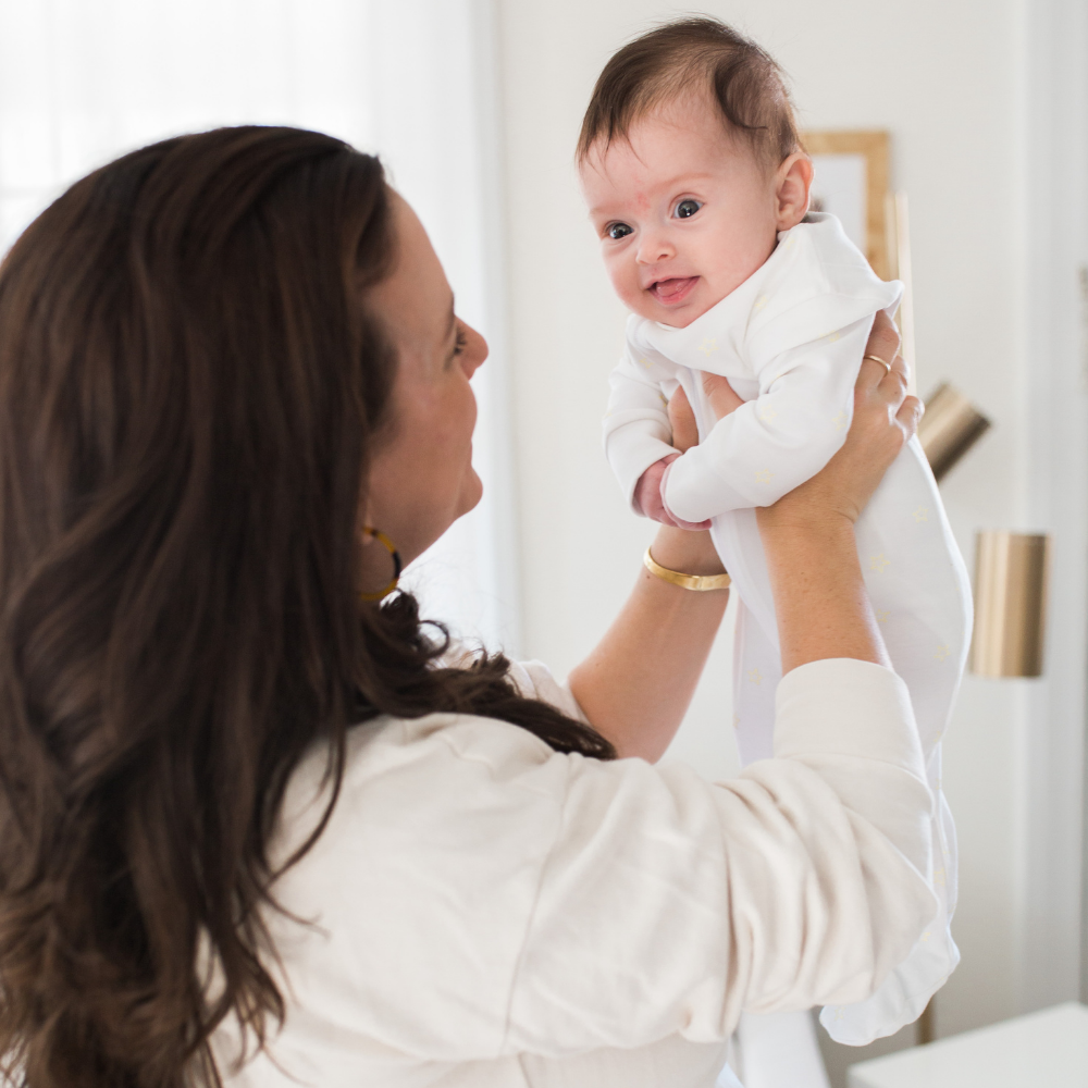 a baby wearing Zipper Romper in White with Light Pink Picot Trim 3