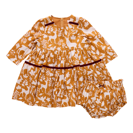 Children's outfit with mustard yellow and white pattern on a white background