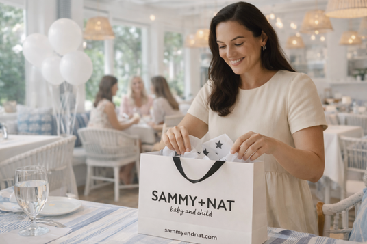 woman at baby shower opening her gift