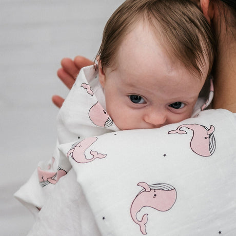 a baby and a mother using Organic 2-Pack Muslin Burp Cloth in Pink Whale