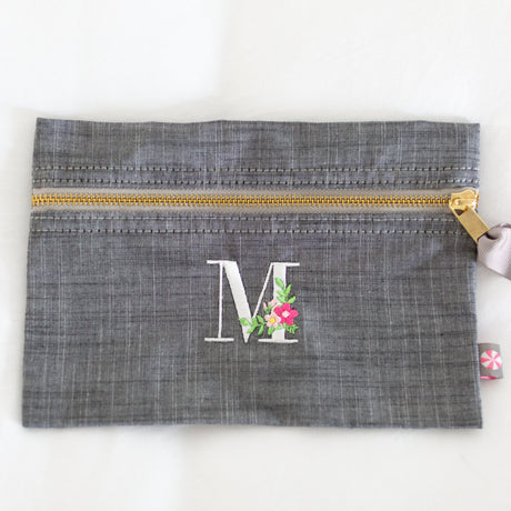 grey pouch with monogram