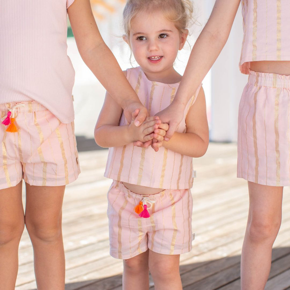 little girl wearing pink kelly short