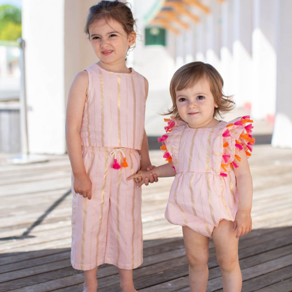 girl wearing taryn pink pant with baby wearing emma romper