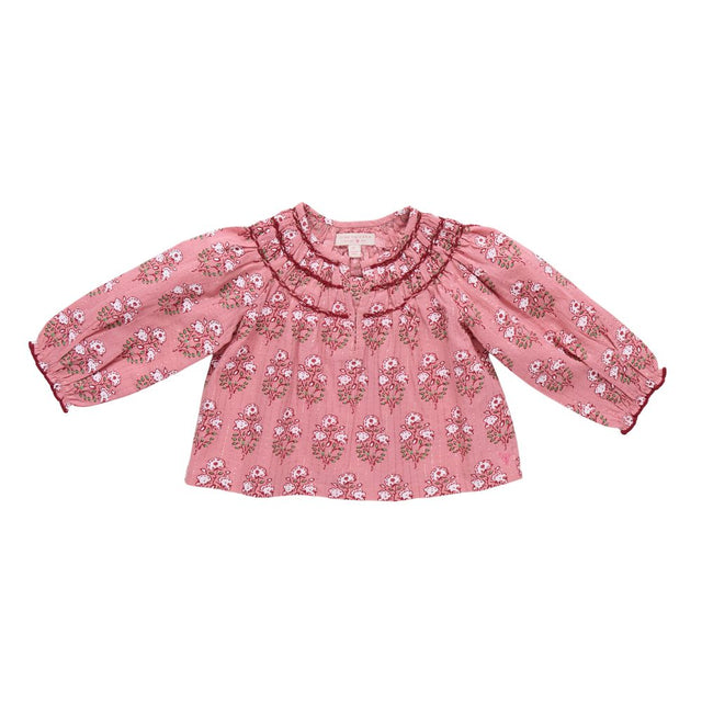 Pink floral blouse with ruffled collar on a white background