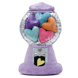 Plush gumball machine with colorful heart-shaped candies on a white background