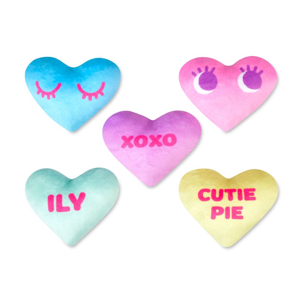 Set of colorful heart-shaped cushions with text on a white background