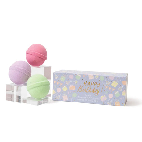 Three bath bombs in pink, purple, and green with a 'Happy Birthday!' box on a white background