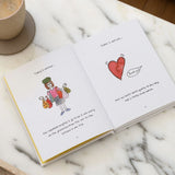 Open book with illustrations and text on a marble surface with a cup of coffee.