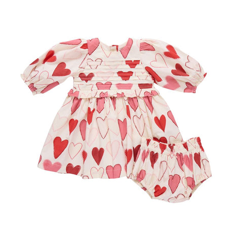 Baby dress and bloomers with heart pattern on a white background