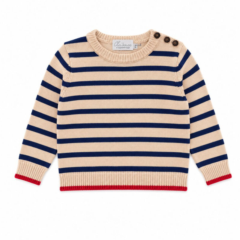 Beige and navy striped sweater with red trim on a white background