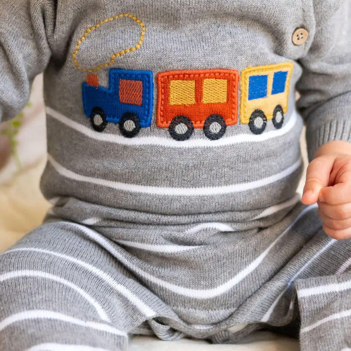 Gray outfit with a colorful train applique on a child