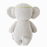 Knitted gray elephant toy on a white background