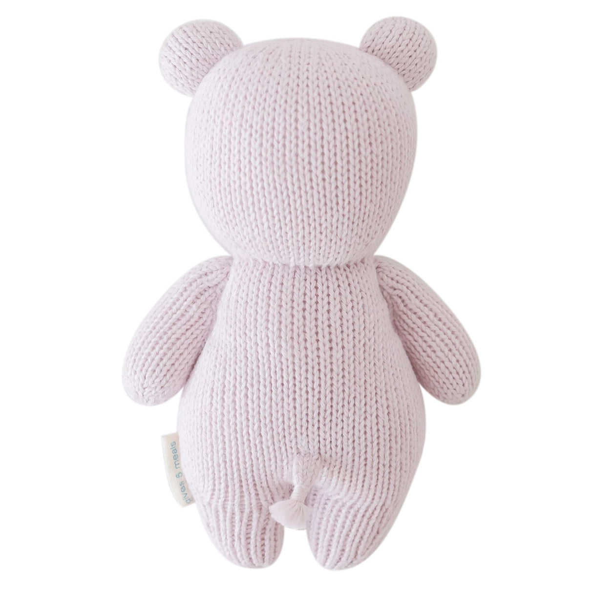 Knitted pink teddy bear toy on a white background