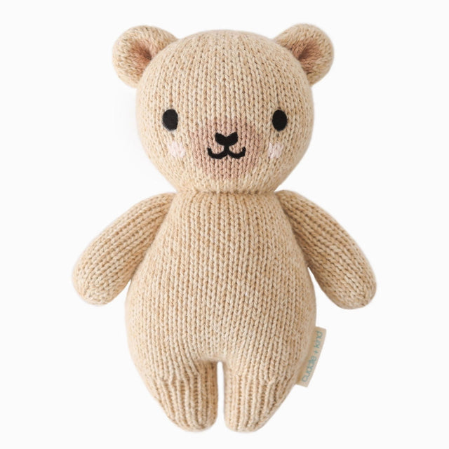 Knitted teddy bear toy on a white background