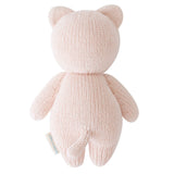 Knitted pink bear toy on a white background
