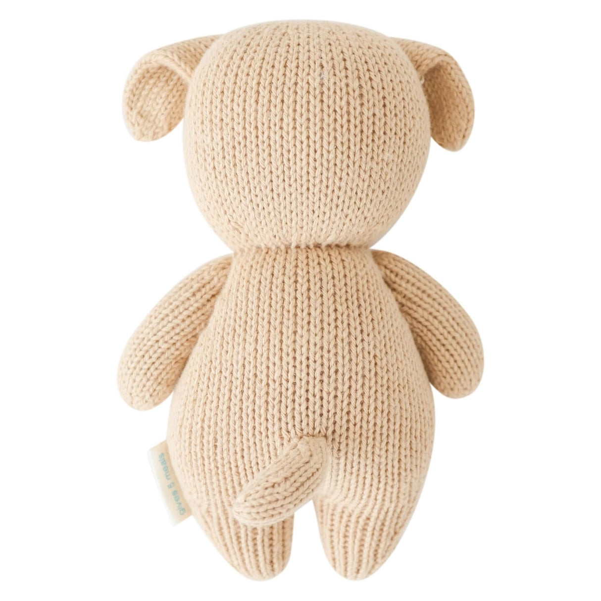 Knitted beige teddy bear toy on a white background