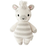 Knitted toy zebra with a white and gray striped body on a white background