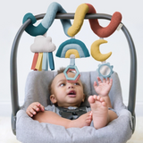 a baby palying with Rainbow Bespoke Spiral Car Seat Activity Toy
