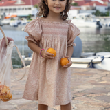 a girl wearing Caroline Dress in Garden Flowers
