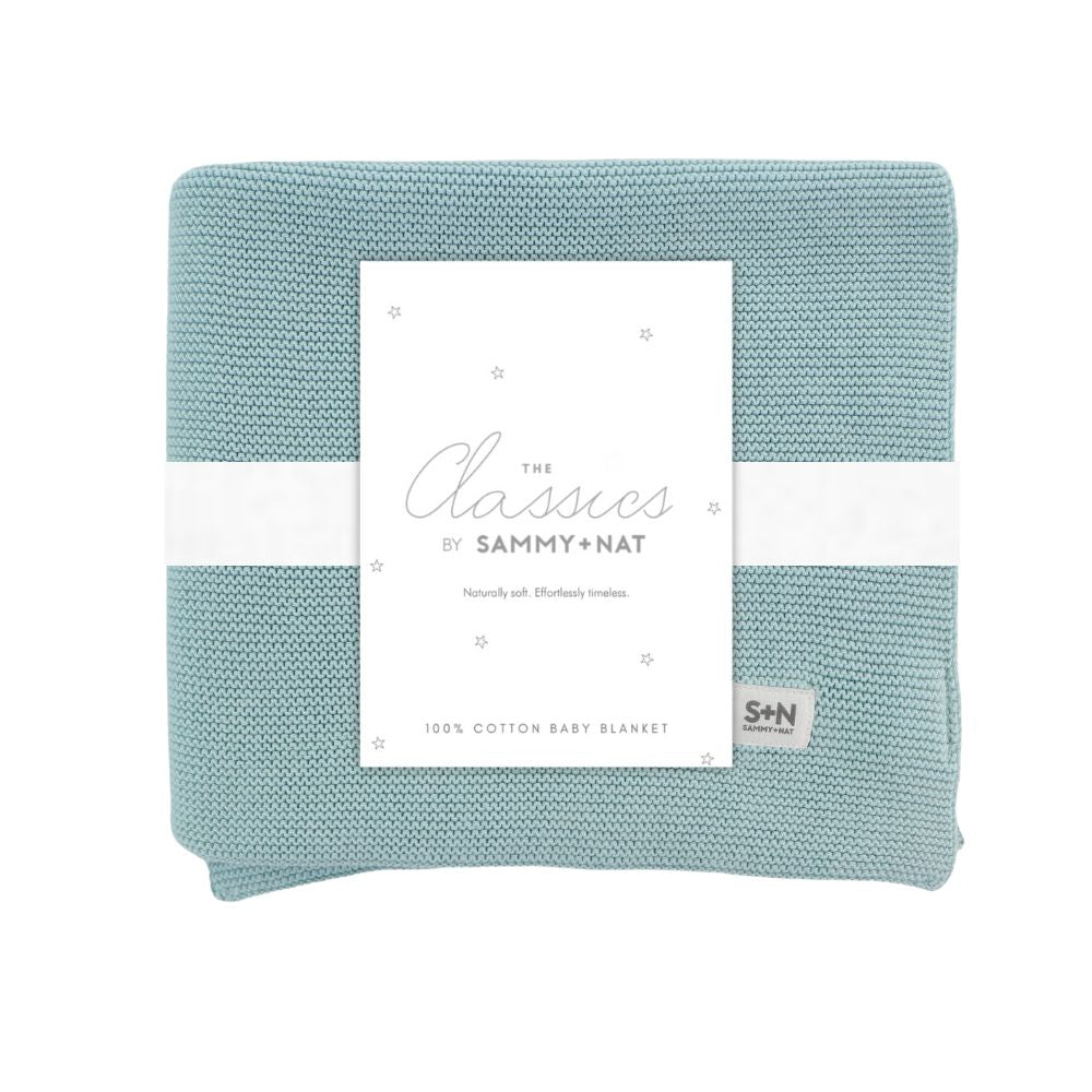 Light blue baby blanket with a white label featuring 'Sammy + Nat' branding on a white background.
