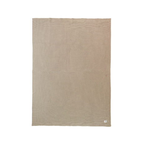 Beige blanket with a subtle pattern on a white background