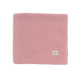 Pink knitted blanket with a brand label on a white background