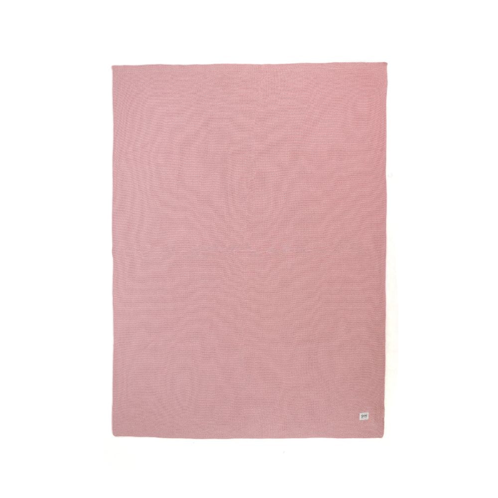 Pink textured blanket on a white background