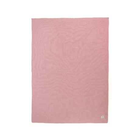 Pink textured blanket on a white background
