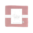 Pink baby blanket with a white label on a white background
