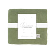 Green baby blanket with a white label on a white background