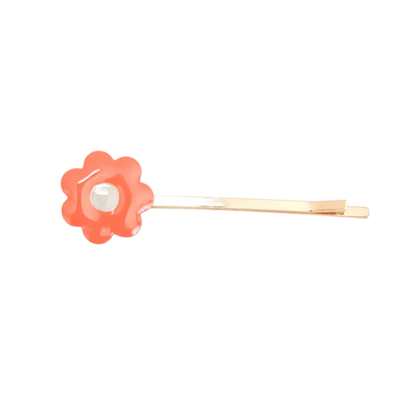Floral hair clip with a pearl center on a white background