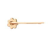 Gold hairpin with floral design on a white background