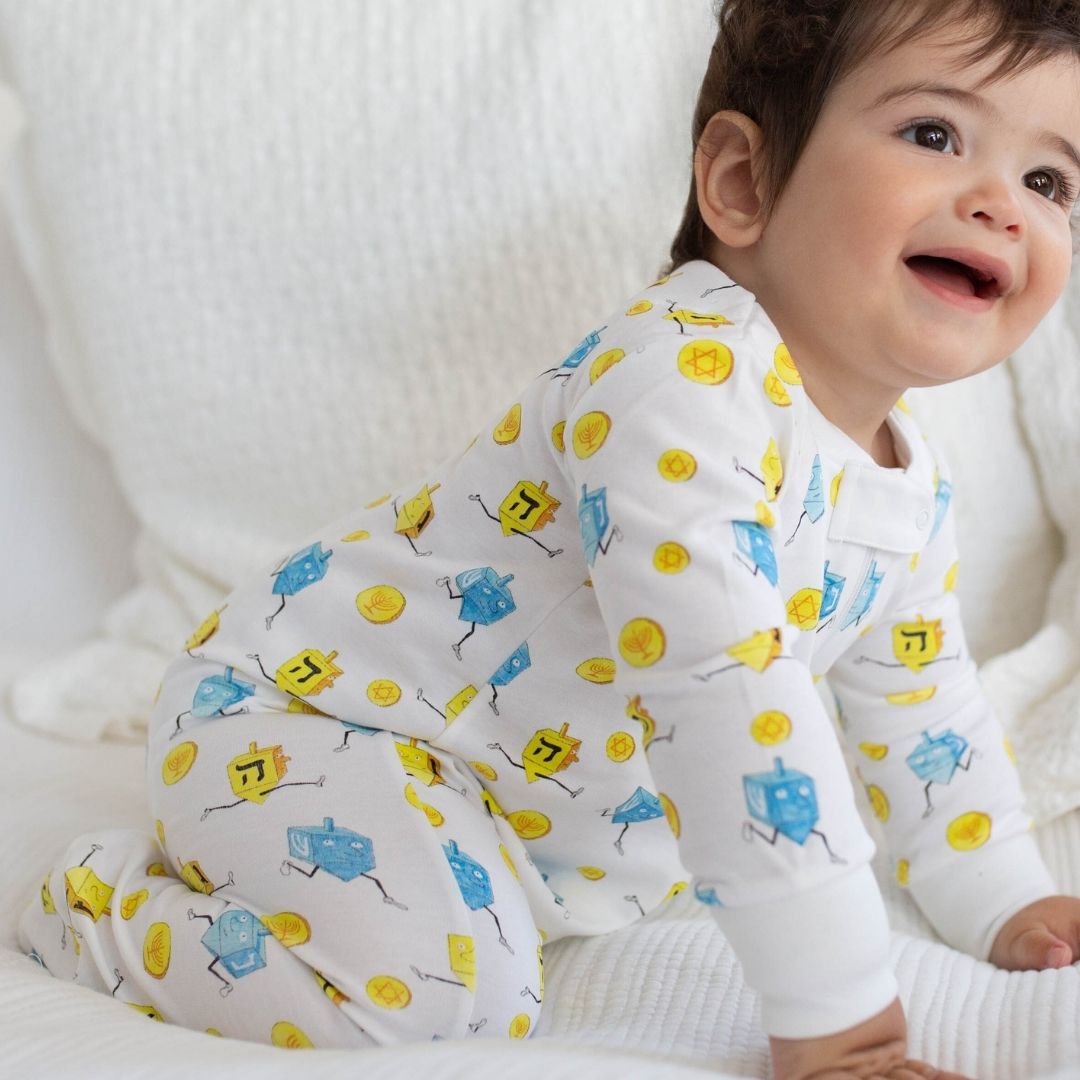 a baby wearing Dancing Dreidel Zipper Romper