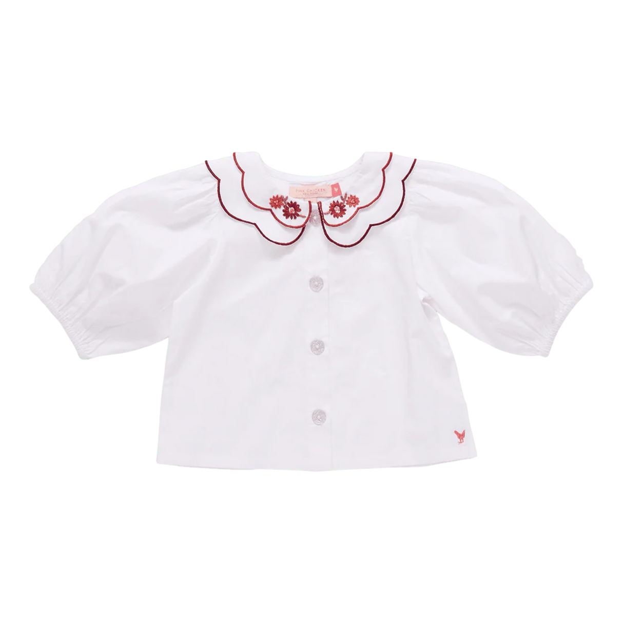 White blouse with red embroidery on a white background