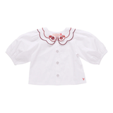 White blouse with red embroidery on a white background