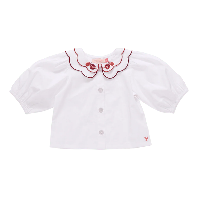 White blouse with red embroidery on a white background