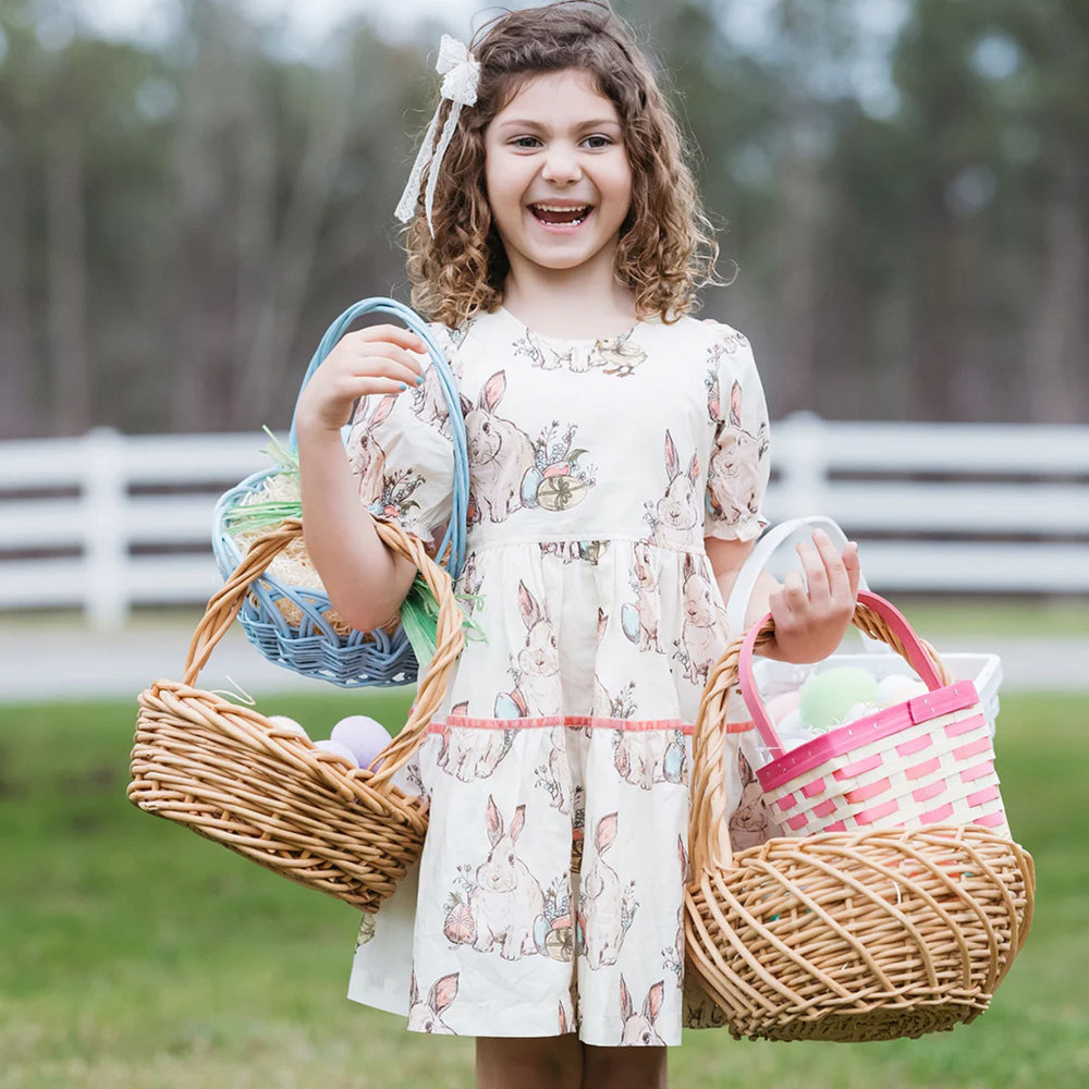 Maribelle Dress - Bunny Friends a girl holding baskets