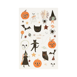 Sheet of Halloween-themed temporary tattoos with pumpkins, cats, ghosts, and witches on a white background.