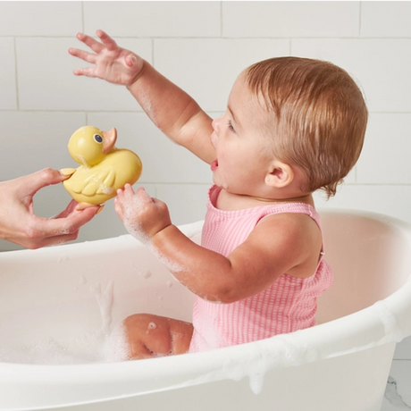 a baby playing with Ducky Family