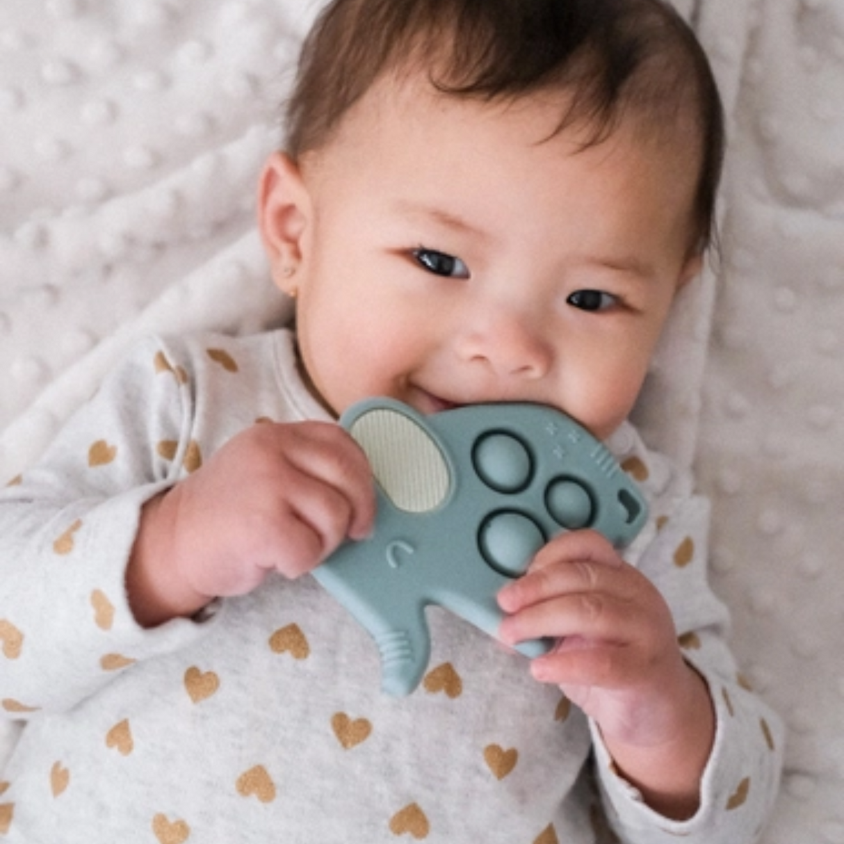 a baby biting the Elephant Itzy Pop Sensory Popper Toy