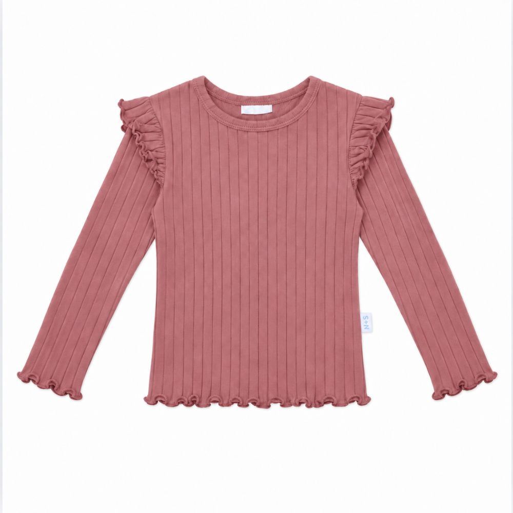 A dusty rose ribbed knit long-sleeve top for kids, featuring ruffled shoulder details and a ruffled hem, shown flat on a white background.