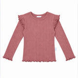 A dusty rose ribbed knit long-sleeve top for kids, featuring ruffled shoulder details and a ruffled hem, shown flat on a white background.