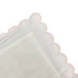 white pillow with pink trim on a white background