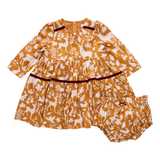 Children's outfit with mustard yellow and white pattern on a white background