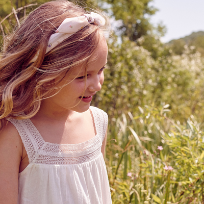 a little girl wearing Lola Hairband in Tiny Flower