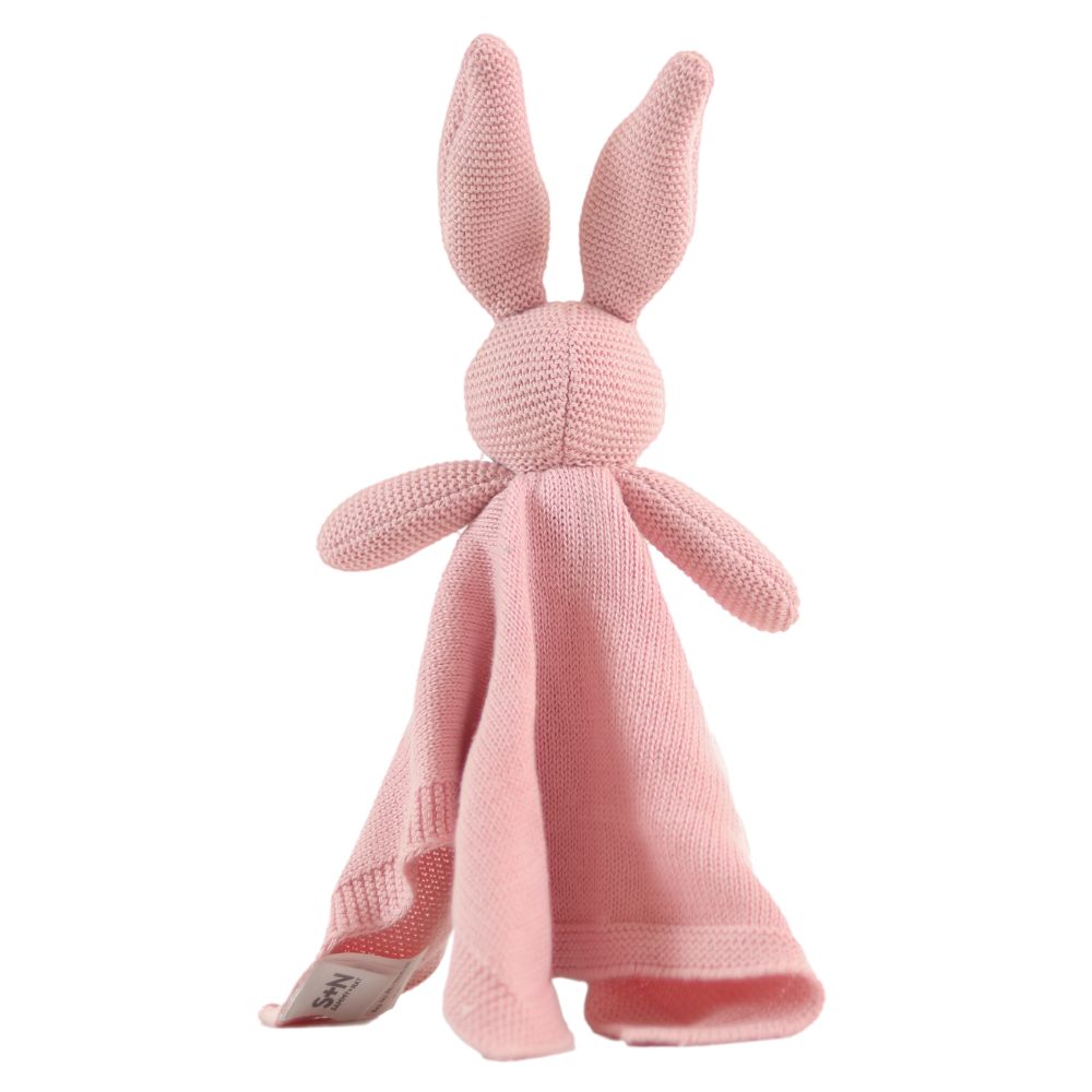 Pink knitted bunny toy with a blanket on a white background