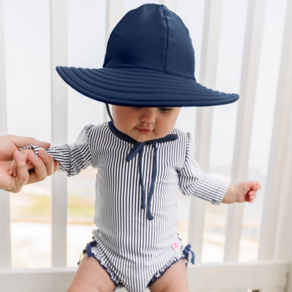 a baby wearing Swim Hat in Navy