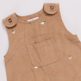 Brown corduroy overalls with button details on a white background