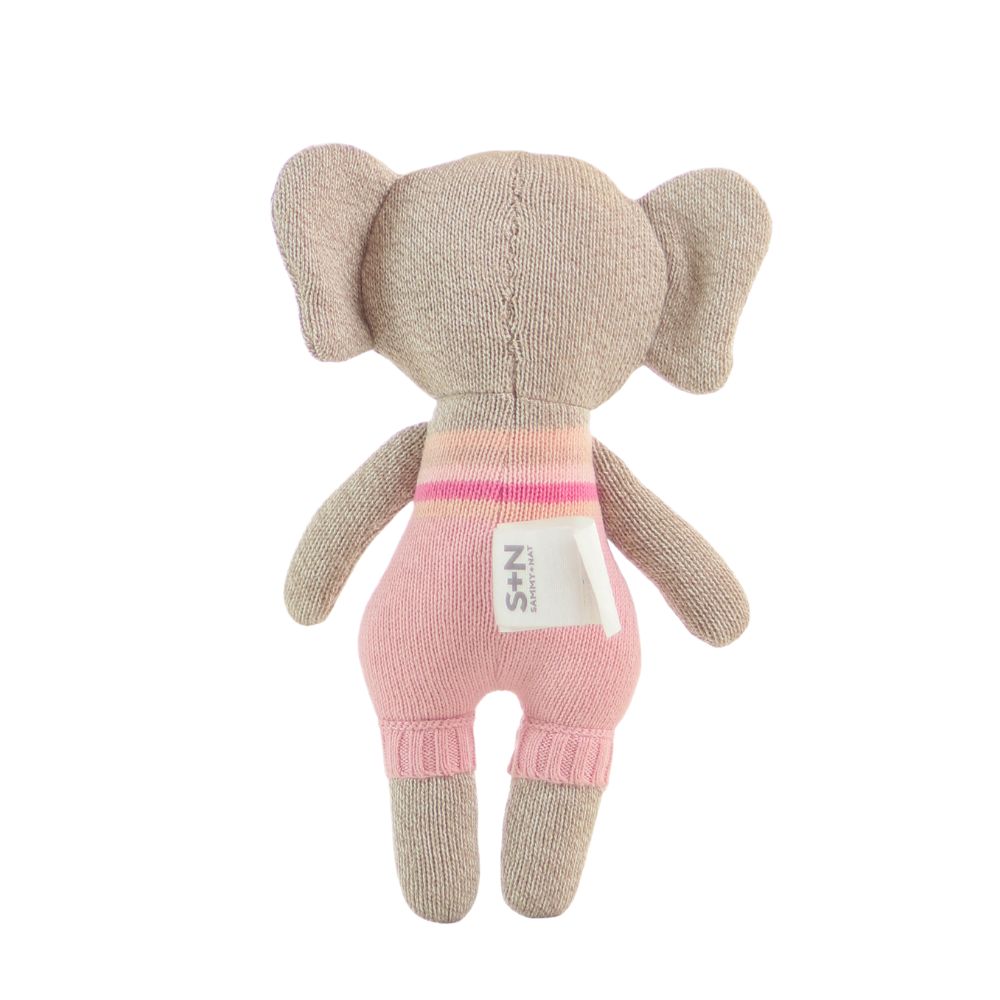Knitted elephant toy with pink outfit on a white background